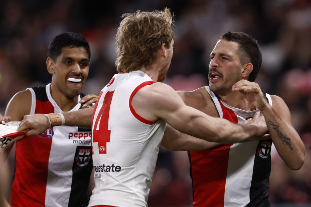 Ben Long of the Saints wrestles with Callum Mills of the Swans.