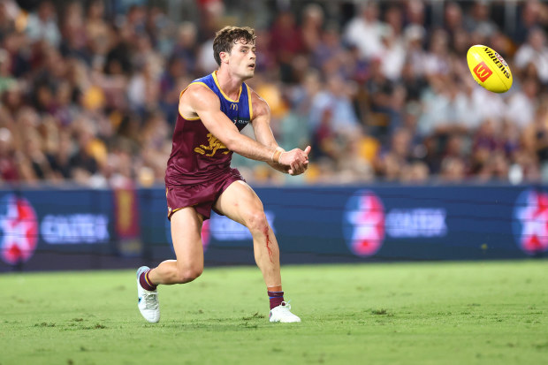 BRISBANE, AUSTRALIA - MARCH 24: Josh Dunkley of the Lions handballs during the round two AFL match between Brisbane Lions and Melbourne Demons at The Gabba, on March 24, 2023, in Brisbane, Australia. (Photo by Chris Hyde/Getty Images)