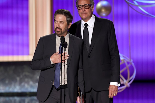 LOS ANGELES, CALIFORNIA - SEPTEMBER 14: (L-R) Ray Romano and Brad Garrett speak onstage during the 77th Primetime Emmy Awards at Peacock Theater on September 14, 2025 in Los Angeles, California.  (Photo by Kevin Winter/Getty Images)