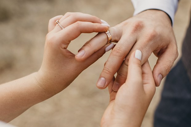 Wedding ring on finger stock