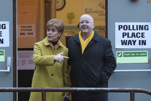 Scottish First Minister Nicola Sturgeon poses for the media with husband Peter Murrell, outside polling station in Glasgow, Scotland, on Dec. 12, 2019. 