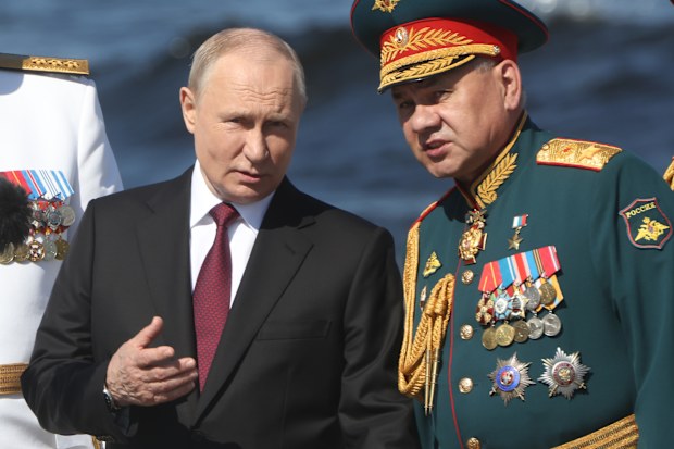 SAINT PETERSBURG, RUSSIA - JULY 30 (RUSSIA OUT) Russian President Vladimir Putin (L) talks to Defense Minister Sergey Shoigu (R) during an annual Navy Day Parade, on July 30,2023, in Saint Petersburg, Russia. President Putin with 4 African leaders who participated in the Russia-African Summit, reviewed the Naval Day Main Parade on the Neva river. (Photo by Contributor/Getty Images)