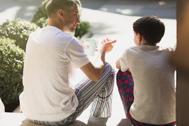 Father with coffee talking to son on front stoop parent conversation children 
