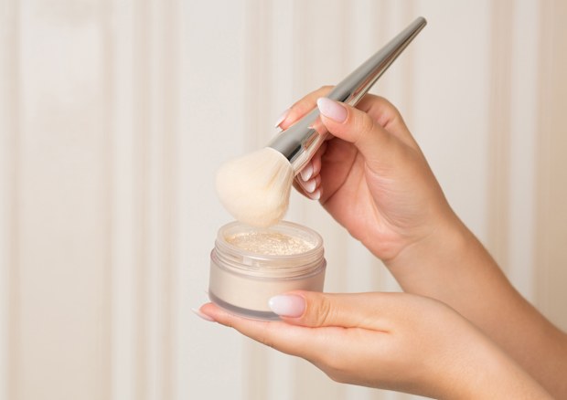 Applying makeup with brush.