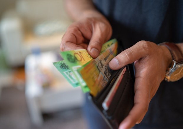 a male taking money out of the valet.