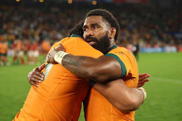 Marika Koroibete of Australia is embraced by Rob Leota.