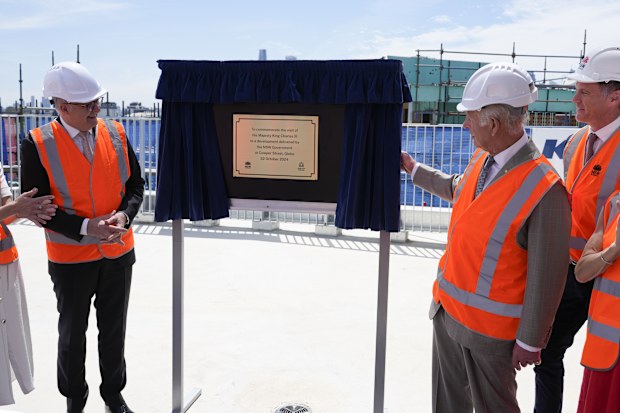 Britain's King Charles III, right, unveils a plaque beside Australia's Prime Minister Anthony Albanese as he visits the Homes NSW Cowper Street development in Sydney, Australia, Tuesday, Oct. 22, 2024.