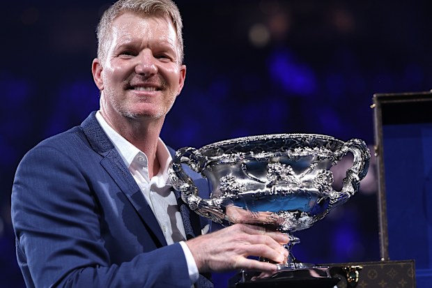Jim Courier carries the Norman Brookes Challenge Cup.