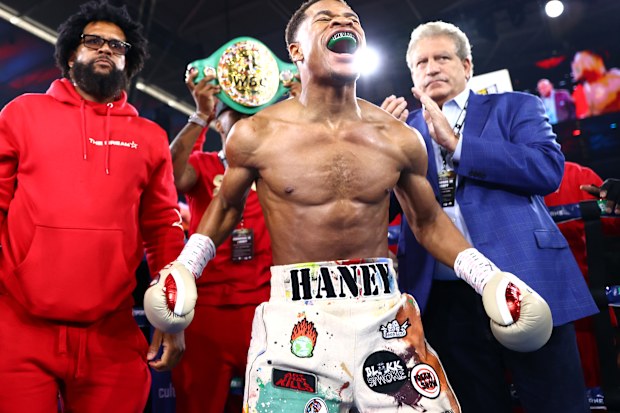 Devin Haney celebrates beating George Kambosos Jr in Melbourne.