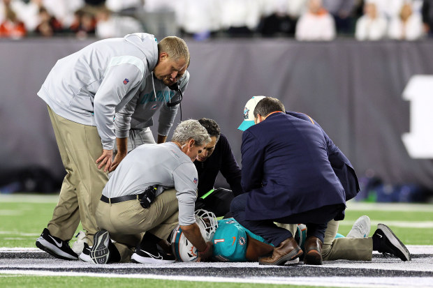 Medical staff tend to quarterback Tua Tagovailoa of the Miami Dolphins.