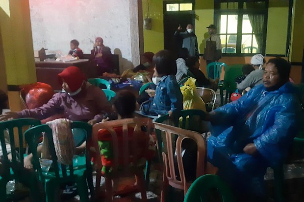 Villagers rest at a temporary shelter after evacuate their homes following the eruption of Mount Semeru at sumberwuluh village in Lumajang, East Java, Indonesia, Saturday,  Dec 4, 2021. 