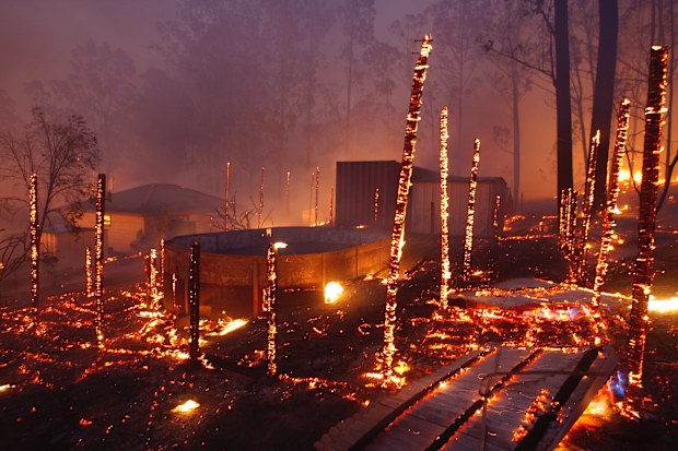 Photographs shows burning properties in Rainbow Flat last night after fire from the Hillville Fire broke containment lines and crossed the Pacific Highway Several homes and countless structures were lost in the area. The remains of a truck is left to burn on the Pacific Highway after fire closed the Highway.