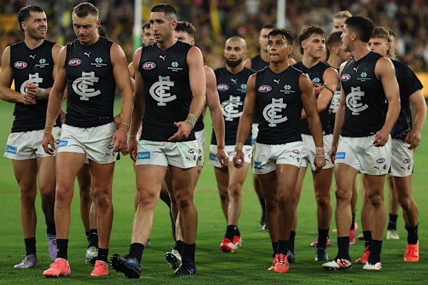 Carlton players trudge off after losing to Richmond.