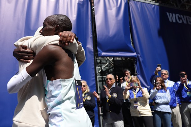 Men's winner John Korir embraced his brother Wesley who won the marathon in 2012 after crossing the finish line of the 129th Boston Marathon.