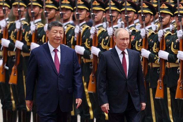 Russian President Vladimir Putin, right, and Chinese President Xi Jinping inspect an honor guard during a welcoming ceremony at the Great Hall of the People in Beijing Wednesday, May 20, 2026. (Maxim Shemetov/Pool Photo via AP)