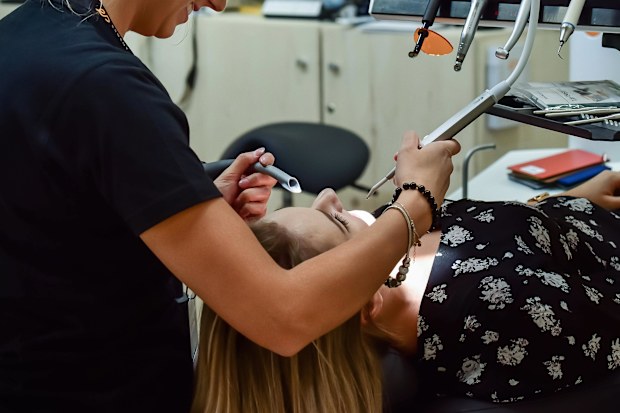 Stock image of a woman at the dentist.