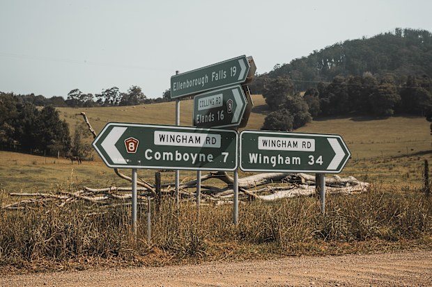 Road signs at an intersection of an unsealed gravel road at Comboyne, New South Wales. The intersection of Colling Road and Wingham Road.