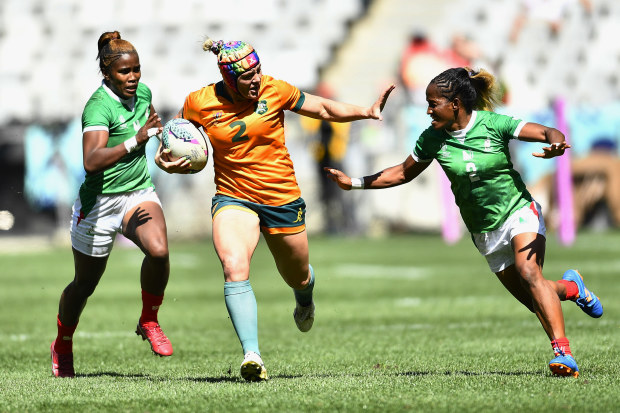 Sharni Williams fends off a Madagascar placer during the Women's Rugby World Cup Sevens in Cape Town.