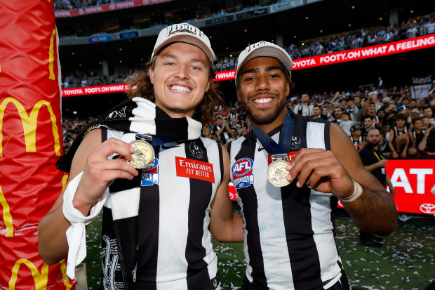 MELBOURNE, AUSTRALIA - SEPTEMBER 30: Jack Ginnivan and Isaac Quaynor of the Magpies pose for a photo with their premiership medals during the 2023 AFL Grand Final match between the Collingwood Magpies and the Brisbane Lions at the Melbourne Cricket Ground on September 30, 2023 in Melbourne, Australia. (Photo by Dylan Burns/AFL Photos via Getty Images)