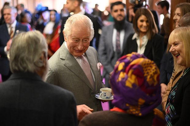 King Charles III talks to guest as he visits Luton Town Hall on December 6, 2022 in Luton, England. 