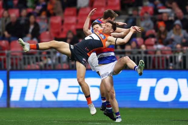Toby Greene and Taylor Duryea compete for the ball. Greene would land on Duryea's leg. Photo: Matt King