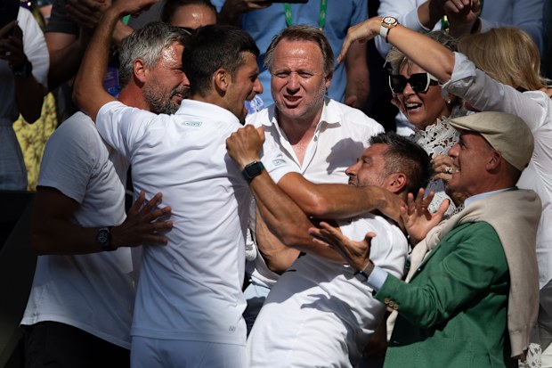 Novak Djokovic of Serbia hugs his team and family after winning his match against Nick Kyrgios of Australia during their Men's Singles Final match on day fourteen of The Championships Wimbledon 2022 at All England Lawn Tennis and Croquet Club on July 10, 2022 in London, England. (Photo by Visionhaus/Getty Images)