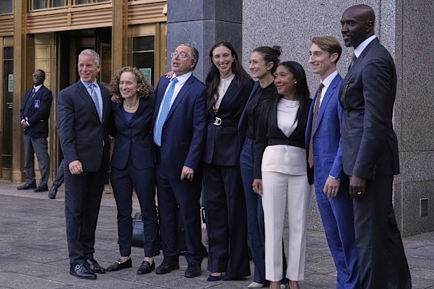 Defense attorneys for Sean "Diddy" Combs, including from left,, Brian Steel, Alexandra Shapiro, Marc Agnifilo and Teny Garagos and Xavier Donaldson, far right, line up for a group photo outside Manhattan federal court after Sean "Diddy" Combs was denied bail after being convicted of prostitution-related offenses but acquitted of sex trafficking and racketeering charges, Wednesday, July 2, 2025, in New York.  