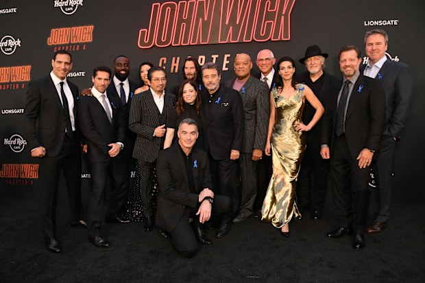 Marko Zaror, Scott Adkins, Shamier Anderson, Rina Sawayama, Hiroyuki Sanada, Keanu Reeves, Erica Lee, Laurence Fishburne, Joe Drake, Natalia Tena, Clancy Brown, David Leitch, Basil Iwanyk and Chad Stahelski (kneeling) attend John Wick: Chapter 4 Los Angeles Premiere at TCL Chinese Theatre on March 20, 2023