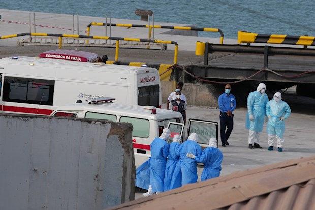 Health workers in protective gear evacuate patients from the MV Hondius cruise ship at a port in Praia, Cape Verde, Wednesday, May 6, 2026. (AP Photo/Misper Apawu)
