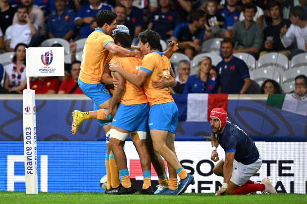 Nicolas Freitas of Uruguay celebrates with his teammates after scoring his team's first try during the Rugby World Cup.