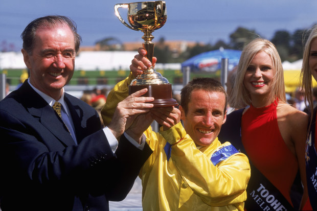 MELBOURNE - NOVEMBER 5:  Damien Oliver, jockey of Media Puzzle, and Trainer Dermott Weld hold the Melbourne Cup trophy after winning the Tooheys New Melbourne Cup at Flemington Racecourse in Melbourne, Australia on November 5, 2002. (Photo by Nick Laham/Getty Images)