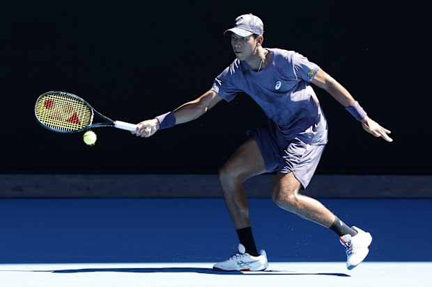 Kasidit Samrej of Thailand plays a forehand against Daniil Medvedev.
