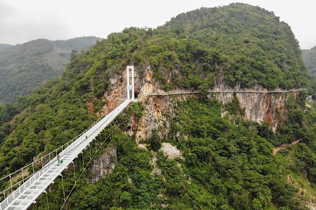 This aerial photo shows the newly constructed Bach Long glass bridge in Moc Chau district in Vietnam's Son La province on April 29, 2022. - Vietnam launched a new attraction for tourists -- with a head for heights -- on April 29 with the opening of a glass-bottomed bridge suspended some 150 metres above a lush, jungle-clad gorge. (Photo by Nhac NGUYEN / AFP) (Photo by NHAC NGUYEN/AFP via Getty Images)