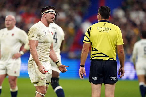 England's Tom Curry speaks to referee Ben O'Keeffe.
