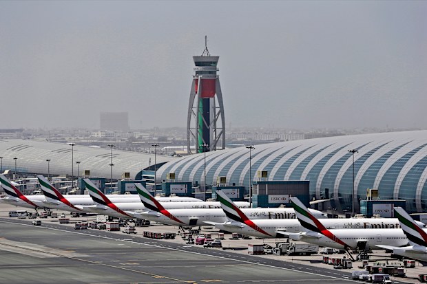 FILE - In this April 20, 2017 file photo, Emirates planes are parked at the Dubai International Airport in Dubai, United Arab Emirates. Major disruptions due to the new coronavirus have already caused the equivalent of a roughly $100 million loss to airline carriers in the Middle East region, which serves as a connection hub for east-west travel, the industry's main trade association said on Monday, March 2, 2020. (AP Photo/Kamran Jebreili, File)
