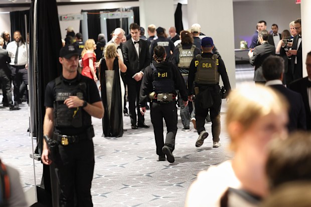 Law enforcement respond during an incident at the White House Correspondents Dinner, Saturday, April 25, 2026, in Washington. (AP Photo/Tom Brenner)