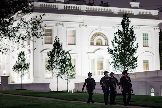 US Secret Service agents patrol the North Lawn at the White House.