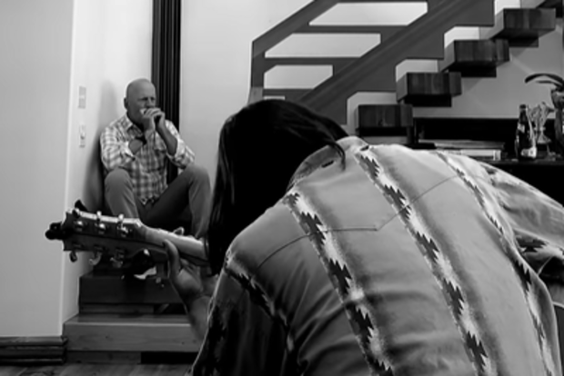 Bruce Willis pictured jamming on the harmonica with friends.