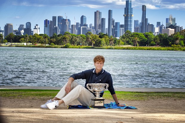 Jannik Sinner with the Australian Open silverware on the banks of the Yarra River.