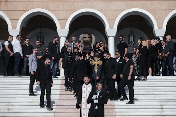 The coffin of slain Greek Australian John Macris is carried out of an Orthodox church after his funeral ceremony south of Athens (AP Photo/Yorgos Karahal)