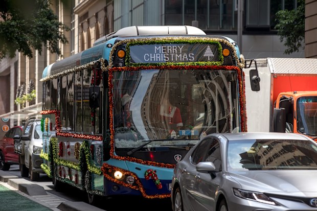 A Christmas themed bus in Sydney, Australia, on Wednesday, Dec. 10, 2025. Australian consumers remain cautious with real per-capita spending broadly flat and the savings ratio edging higher as households rebuild financial buffers. Photographer: Brent Lewin/Bloomberg