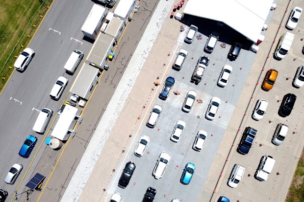 Cars queue for the COVID-19 testing facility at Victoria Park, just outside the Adelaide CBD