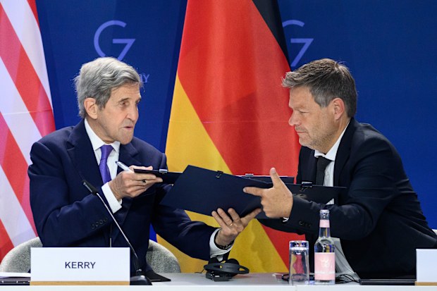 German Economy and Climate Minister Robert Habeck, right, and John Kerry, left, Special Envoy of the U.S. President for Climate, sign a declaration of intent to establish a German-American climate and energy partnership between the United States of America and Germany at the meeting of the G7 Ministers for Climate, Energy and Environment in Berlin, Germany, Friday, May. 27, 2022.