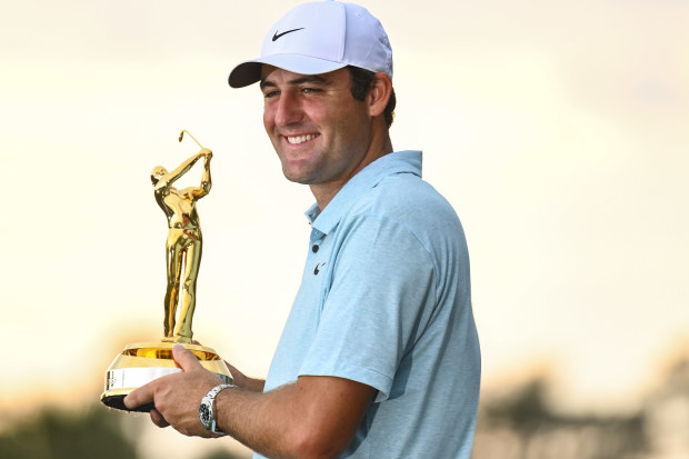 Scottie Scheffler smiles with the tournament trophy after his five stroke victory in the final round of THE PLAYERS Championship on the Stadium Course at TPC Sawgrass on March 12, 2023 in Ponte Vedra Beach, Florida. (Photo by Keyur KhamarPGA TOUR via Getty Images)