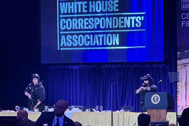 U.S. Secret Service agents respond on stage during the White House Correspondents Dinner, Saturday, April 25, 2026, in Washington. (AP Photo/Alex Brandon)