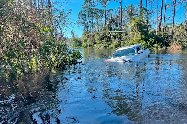 A car is submerged in flood water in North Port, Florida on Friday, September 30, 2022.