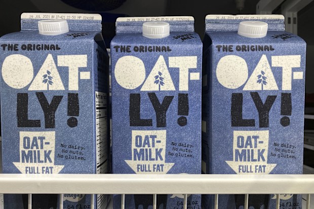 Oatly containers are displayed at a grocery store.