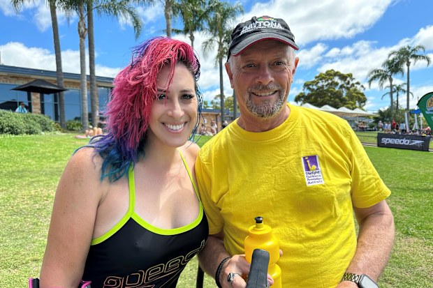 Lucy Woolfman poses in her swimsuit with a friend.
