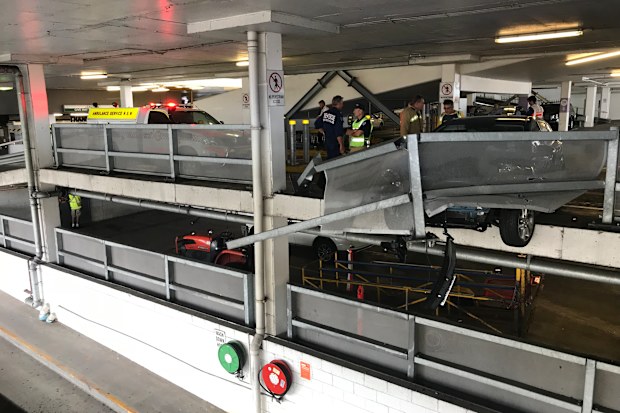 The car's front wheels were left hanging over the edge of the third-storey carpark. (9NEWS)