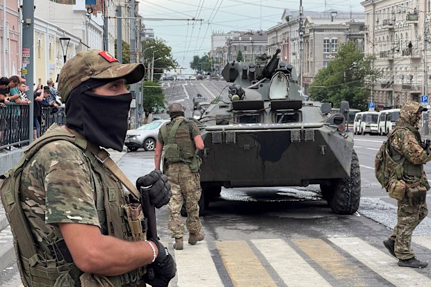 Fighters of Wagner private mercenary group stand guard in a street near the headquarters of the Southern Military District in the city of Rostov-on-Don, Russia, June 24, 2023. REUTERS/Stringer